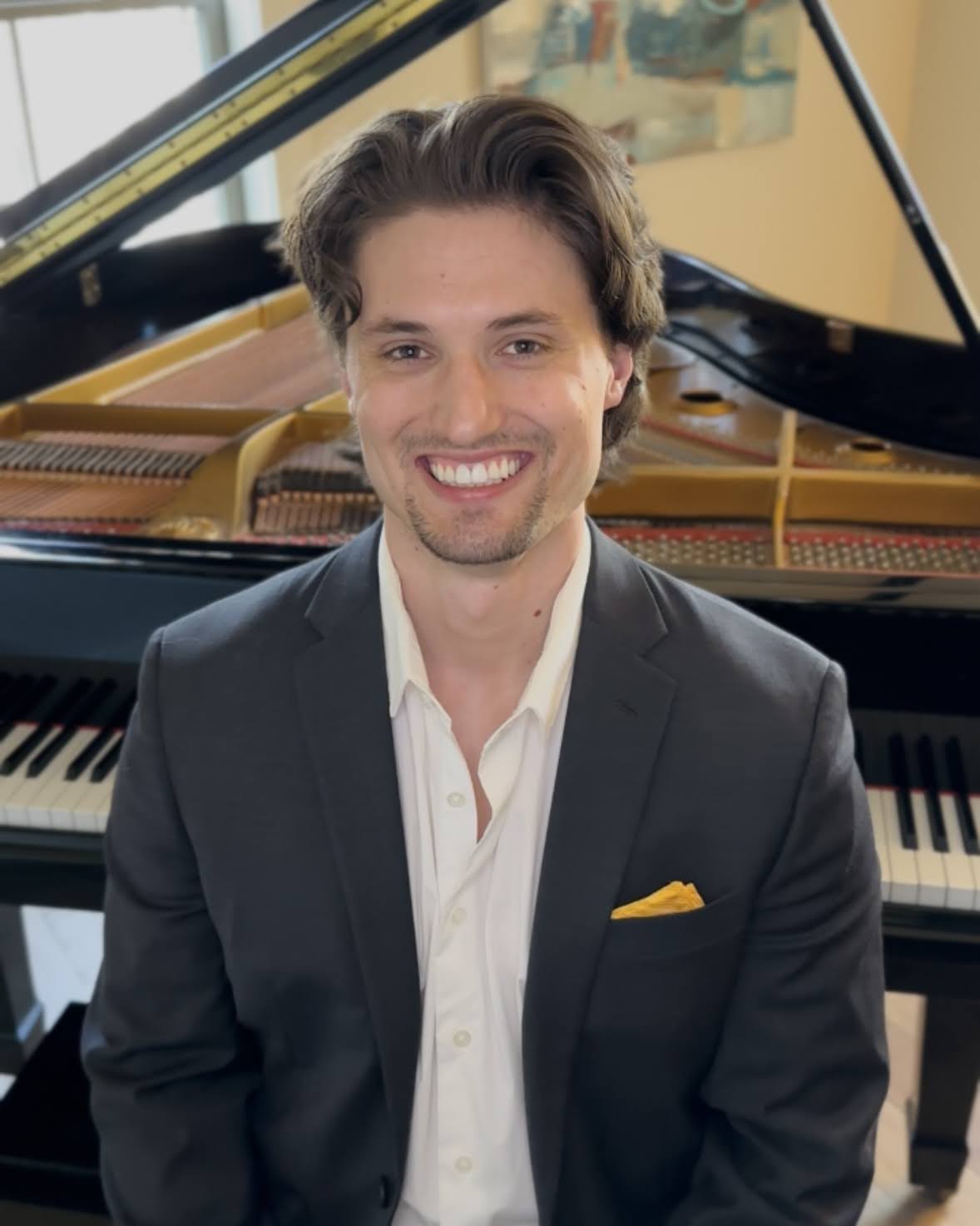 Canaan Howell seated at a grand piano